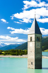 tower of sunken church in Resia lake, South Tyrol, Italy