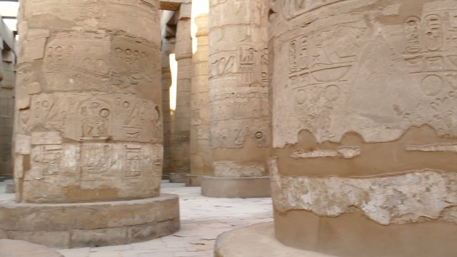 columns in karnak temple with ancient egypt hieroglyphics - pan 