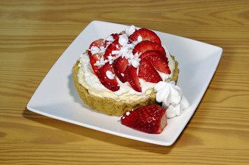 Cake with whipped cream and strawberries.