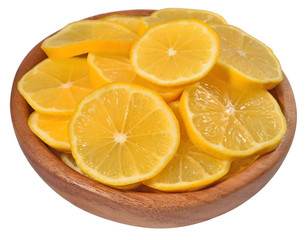 Lemon slices in a wooden bowl on a white