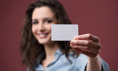 Young woman holding a business card