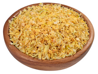 Dried onions in a wooden bowl on a white