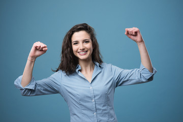 Cheerful woman with raised fists