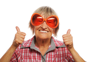 Senior woman wearing big sunglasses doing funky action