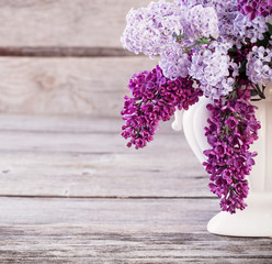 Still life with a blooming branch of lilac