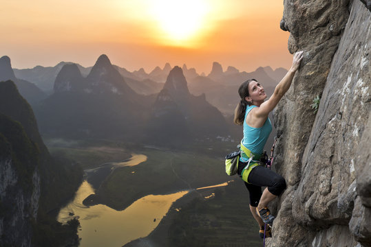 Female climber against sunset at Li River