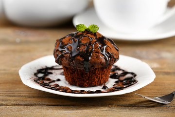 Yummy chocolate cupcake on table