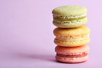 Assortment of gentle colorful macaroons on color background