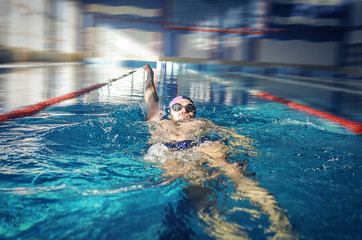 Swimmer swimming backstroke
