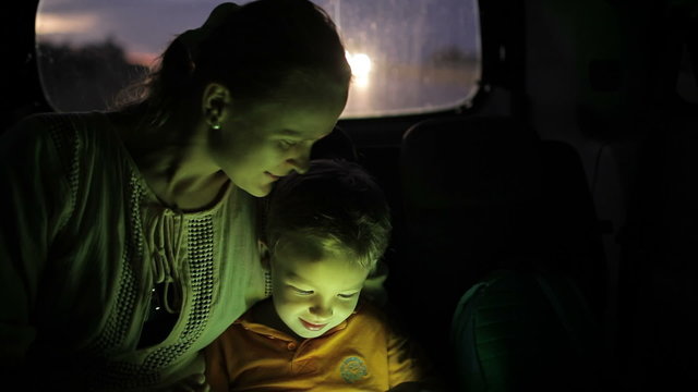 Little Boy Using Tablet Pc During Car Travel  At Night