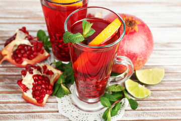 Pomegranate drink in glasses with mint and slices of orange