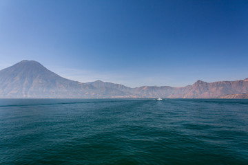 Lake Atitlan boat and volcanoes