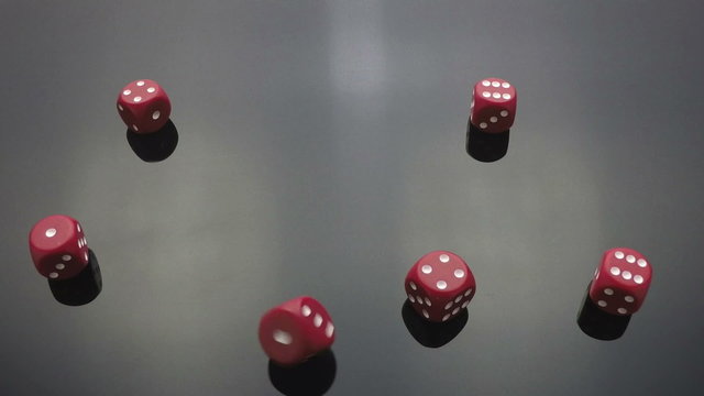 red dice cast on black slow motion