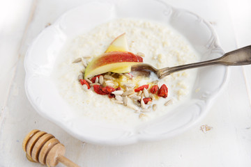 millet porridge with milk,goji berries, apple, honey and seeds
