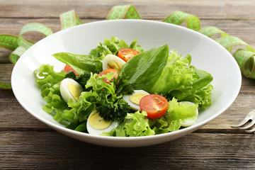 Salad with quail egg and basil in plate