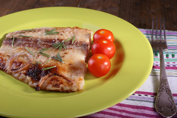Dish of Pangasius fillet with rosemary and cherry tomatoes in