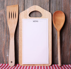 Cutting board with menu sheet of paper, with cherry tomatoes