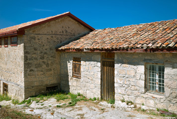 Fototapeta na wymiar ancient stone house tile roof