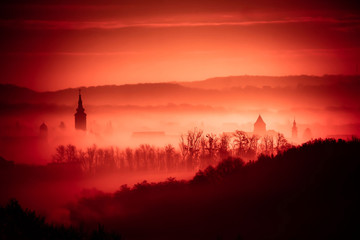 Red foggy dawn in town of Krizevci