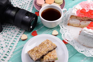 Different sweets and photo camera on table top view