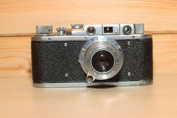 Vintage camera on a wooden background.