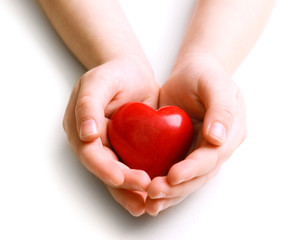 Heart in child hands isolated on white