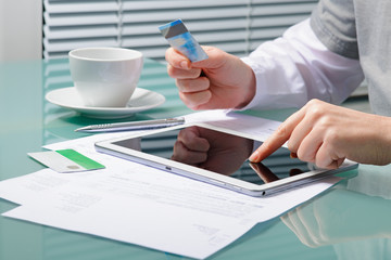 Shopping online with tablet and credit card
