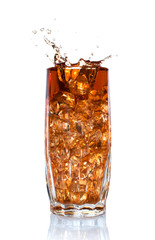 splash of cola in glass with ice