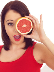 Young Woman Holding a Pink Grapefruit