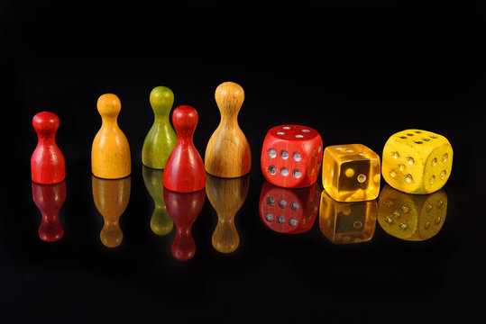 Yellow, red and green figures and playing dice on black
