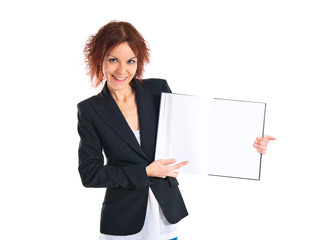 Redhead girl presenting a book