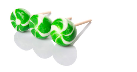 Green swirl peppermint candies over white background
