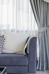 white pillow on blue sofa in modern living room