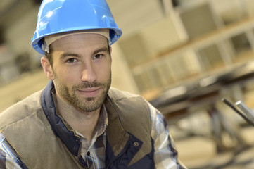 Portrait of industrial engineer wearing safety helmet