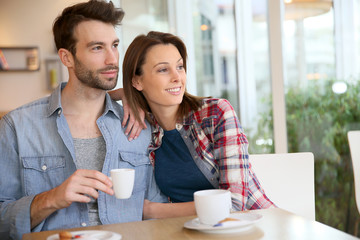 30-year-old couple sitting in coffee shop