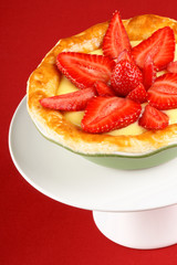 Strawberry and custard tart on a cakestand