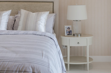 luxury bedroom with white lamp on round table