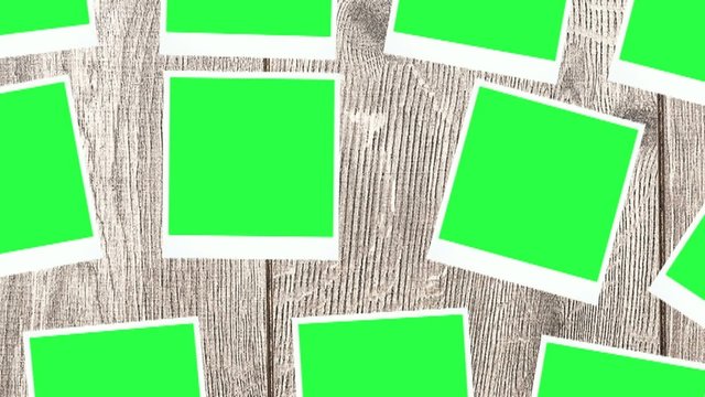 blank photos with a green screen on a wooden background