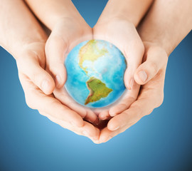 close up of woman and man hands with earth globe