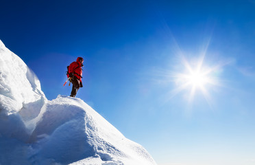 A climber takes a rest looking the mountain panorama.