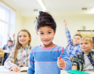 happy little school girl over classroom background