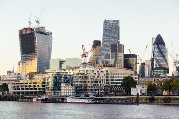 River Thames and Modern Skyscrapers on Background at Sunset