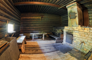 Interior of traditional russian wooden bath with brick oven
