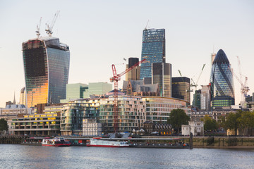 River Thames and Modern Skyscrapers on Background at Sunset