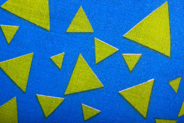 Yellow Fabric Triangles on Blue Textured Material