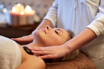 Fototapeta na wymiar close up of woman having hot stone massage in spa