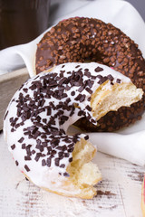 bitten donuts with icing on a white napkin
