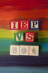 504 Plan VS. IEP (Individualized Education Plan) alphabet blocks