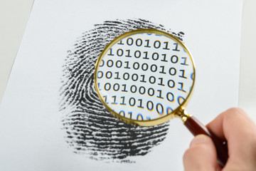 Hand With Magnifying Glass Over A Finger Print