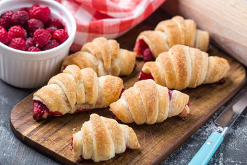 Fresh croissants with raspberries
